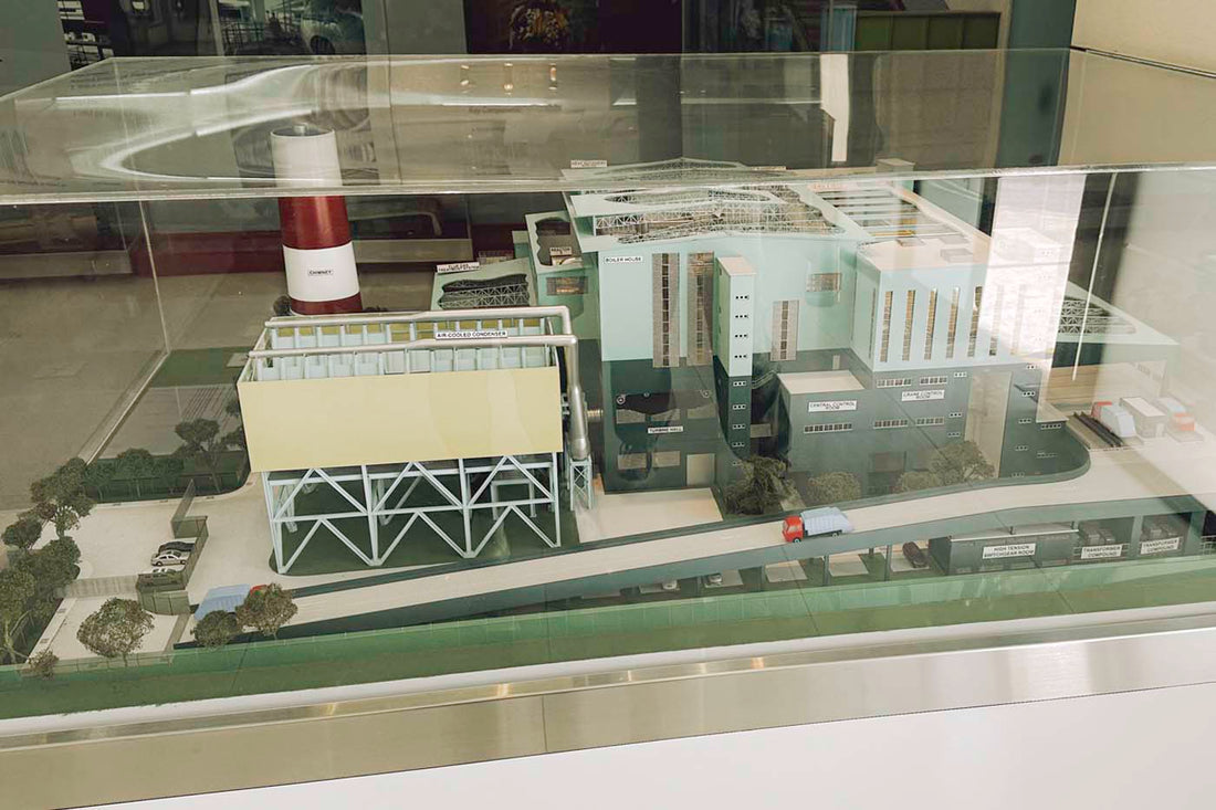 Scale model of the Keppel Seghers Waste-to-Energy plant in Singapore, showing labeled sections such as the air-cooled condenser, incineration building, and chimney.